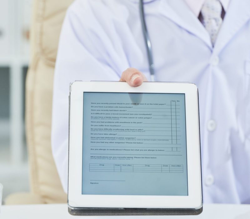 Doctor giving tablet computer with survey to get anamnesis