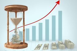 Digital composition of currency flowing through hour glass and stack of dollar bills against graph bar in background
